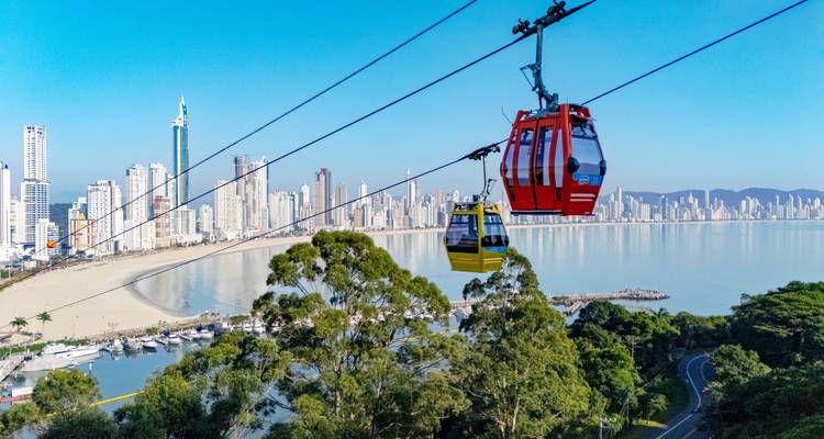 Los coloridos teleféricos se deslizan sobre el horizonte de Balneário Camboriú y la amplia playa de arena