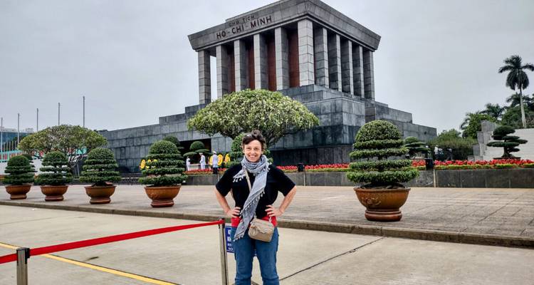 Traveler posing in front of Ho Chi Minh Mausoleum behind a red barrier rope.
