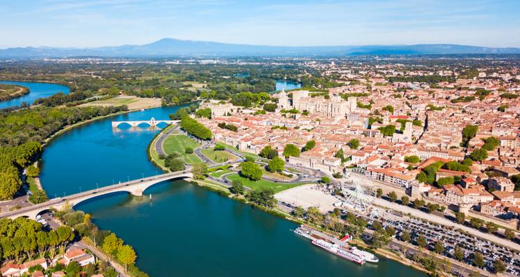 Vue aérienne générale d'Avignon montrant les deux ponts enjambant le Rhône, les rives verdoyantes et le centre historique compact.
