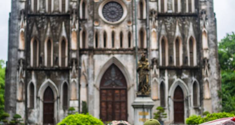 Out-of-focus view of St Joseph’s Cathedral façade in Hanoi with blurred foreground.