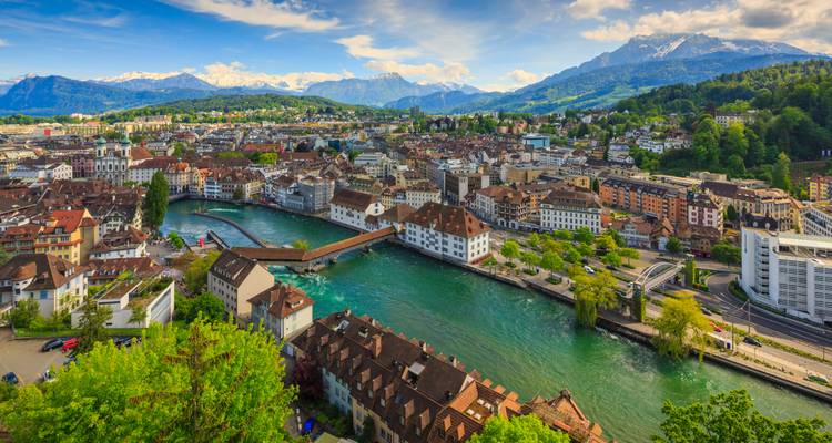 Vue surélevée de la vieille ville aux toits rouges de Lucerne, de la rivière Reuss et des Alpes aux sommets enneigés.