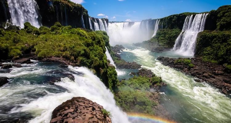 Las espectaculares Cataratas del Iguazú con un arcoíris arqueándose sobre las cascadas rugientes y los acantilados verdes