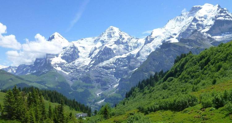 Sneeuwbedekte alpiene toppen van de Jungfraustreek die uitsteken boven het groene dal