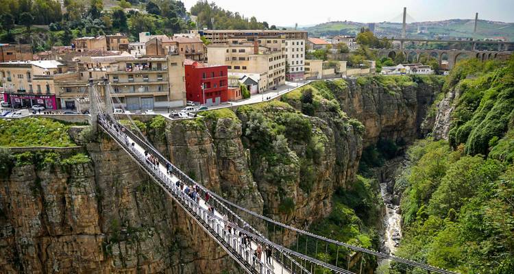 Spektakuläre Hängebrücke, die eine tiefe Kalksteinschlucht überbrückt, mit Blick auf die Stadt Konstantin