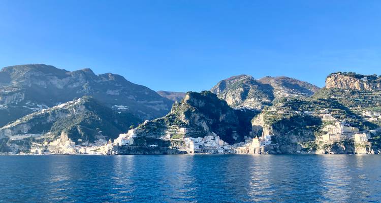 Wide seascape of rugged mountains meeting deep blue water along the Amalfi Coast