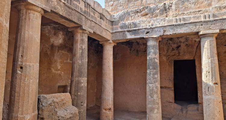 Ancient stone chamber with Doric columns and weathered walls