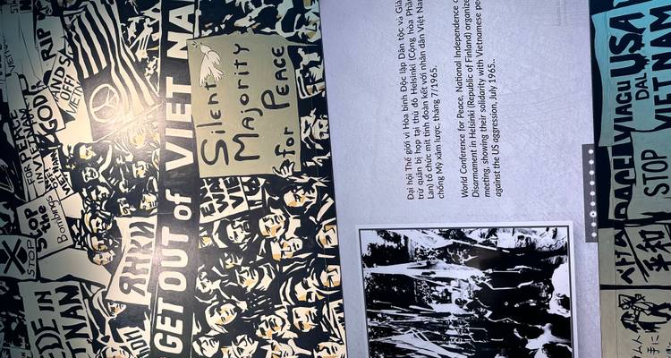 Museum exhibit wall displaying Vietnam War protest posters and historic photographs.