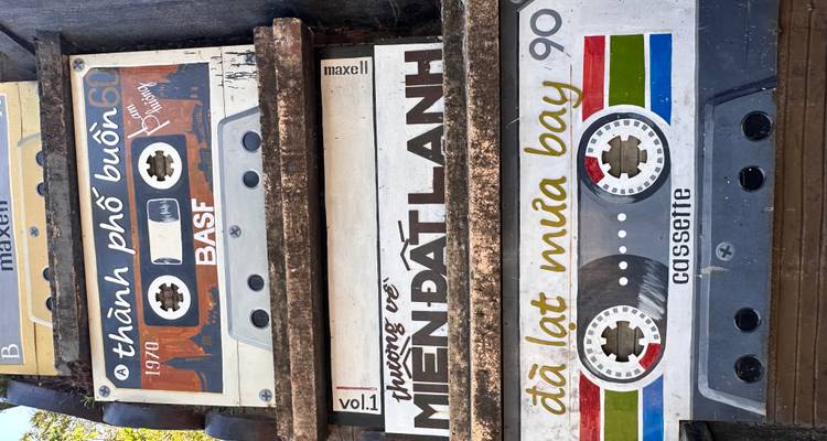 Stacked retro cassette-shaped signs with Vietnamese text and playful graphics.
