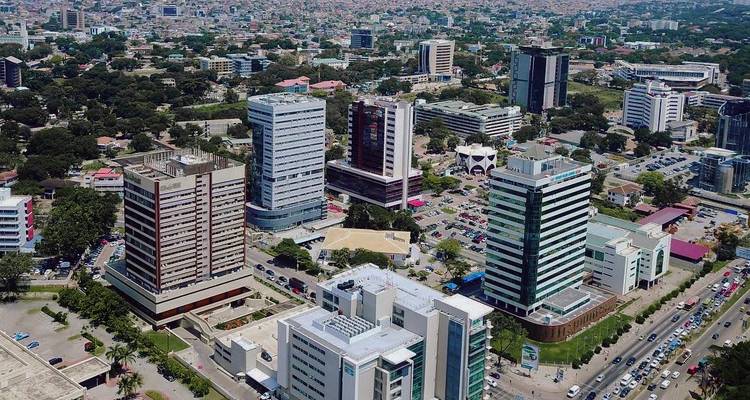 Aerial view of Accra’s modern high-rise business district with sprawling cityscape beyond.