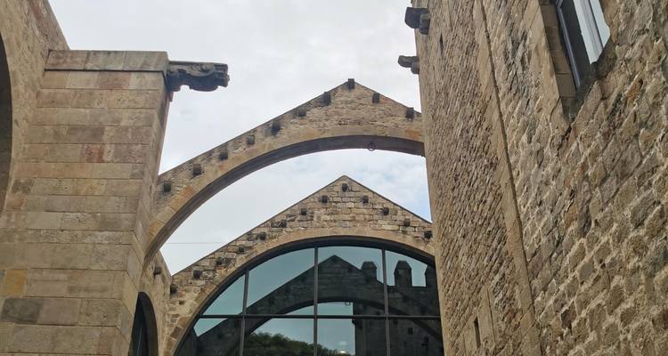Steinbögen und rustikale Mauern eines mittelalterlichen Schiffswerftsgebäudes mit Spiegelungen in Glas