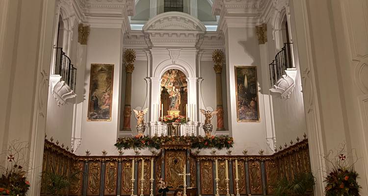 Autel d'église de style baroque avec des détails dorés ornés et des peintures religieuses.