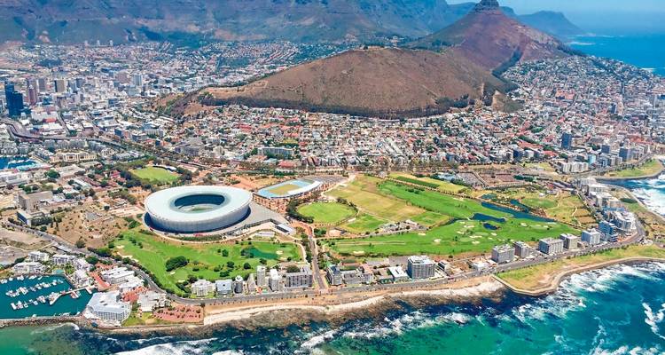 Aerial panorama of Cape Town with stadium, city bowl, Table Mountain and rugged coastline