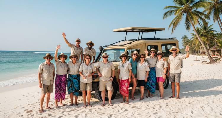 Un jeep de safari estacionado en una playa tropical de arena blanca con un grupo de viajeros saludando bajo las palmeras.