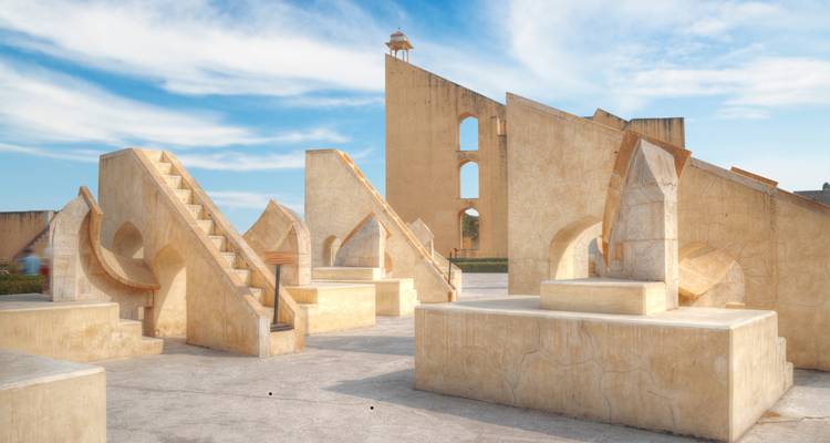 Die steinernen astronomischen Instrumente des Observatoriums Jantar Mantar werfen unter klarem Himmel scharfe Schatten.