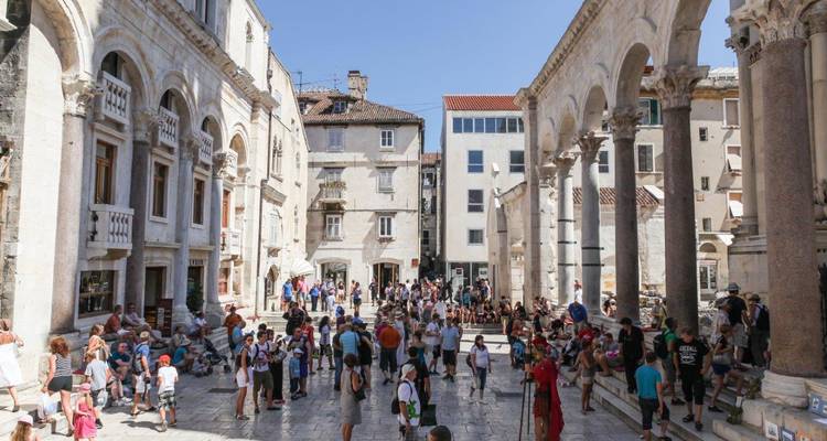 Crowded peristyle courtyard of Split’s Diocletian Palace bustling with tourists on a sunny day