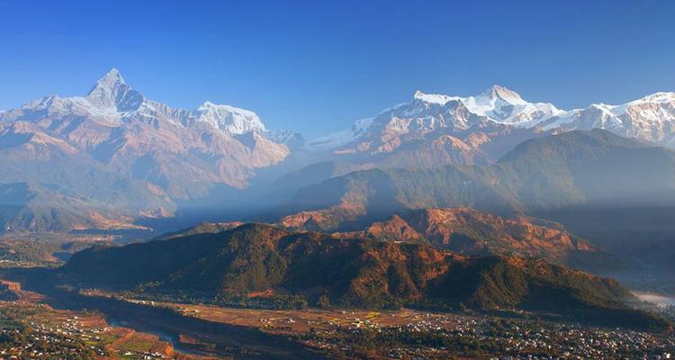 Expansive view of the Annapurna massif towering over Pokhara valley in crisp morning light.
