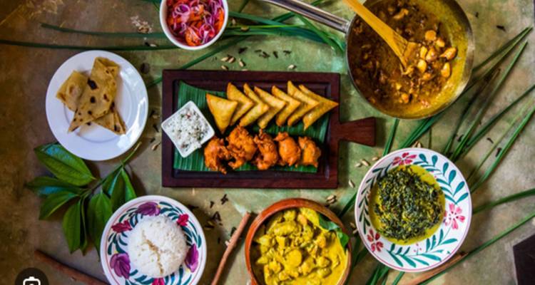 Vibrant overhead display of traditional Swahili dishes including curries, rice, samosas and chapati.
