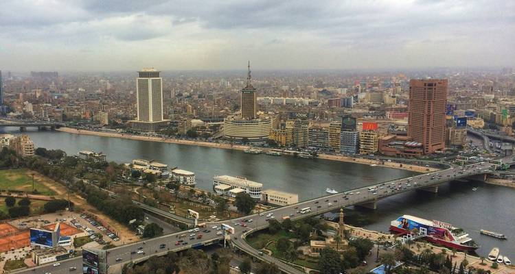 Large vue aérienne de l'horizon du Caire avec le fleuve Nil, les ponts et l'étalement urbain dense par une journée brumeuse.