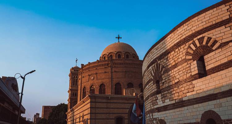 Dôme de l'Église Suspendue dans le quartier copte du Caire sous un ciel du soir bleu clair.