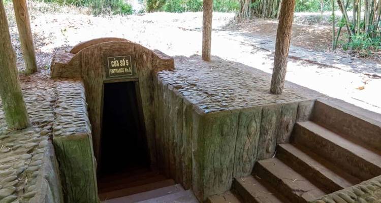 Wooden stairway entrance to section 5 of the Cu Chi Tunnels shaded by bamboo