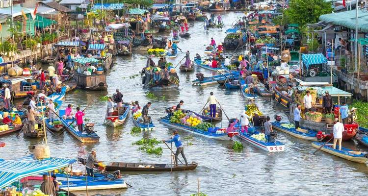 Vibrant floating market packed with colorful produce boats and bustling vendors on a busy canal.