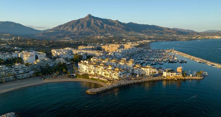 Vue aérienne de la marina de Marbella et du front de mer dominé par la montagne La Concha à l'heure dorée