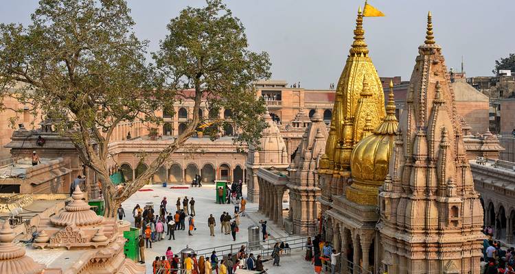 Golden spires of Kashi Vishwanath Temple complex rise above pilgrims in Varanasi.