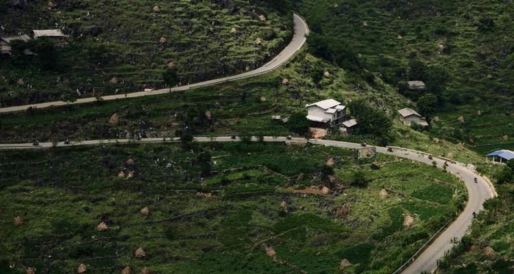 Carretera de montaña sinuosa que serpentea a través de las laderas escalonadas y verdes del norte de Vietnam