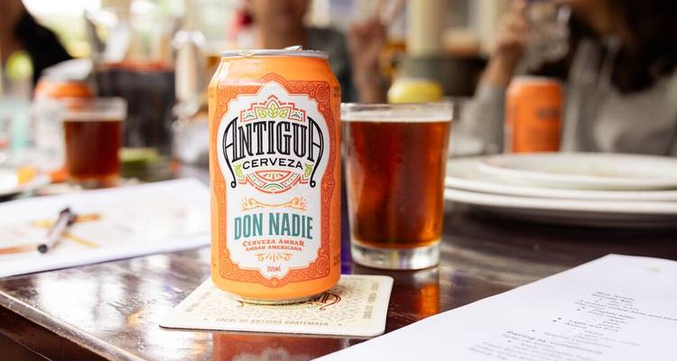 Canned beverage on a table with blurred background.