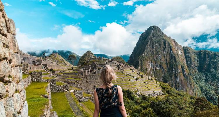 Person overlooking the ruins of Machu Picchu.