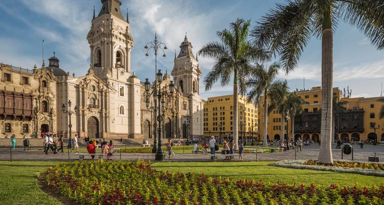 Colonial architecture in a city square with gardens.