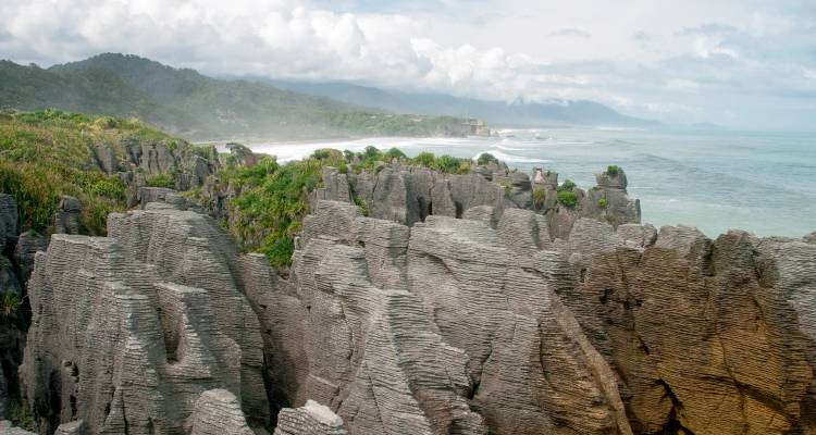 Rock formations resembling pancakes near the coast.