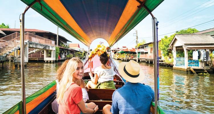 People enjoying a boat tour on a waterway.