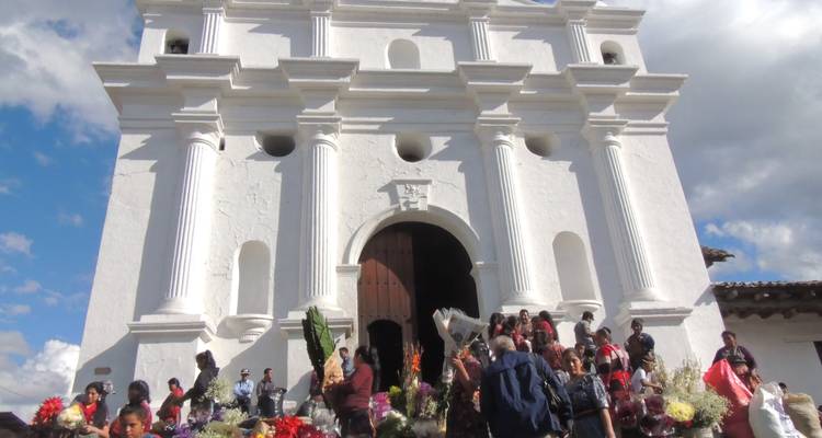 Crowd with flowers in front of a historic church
