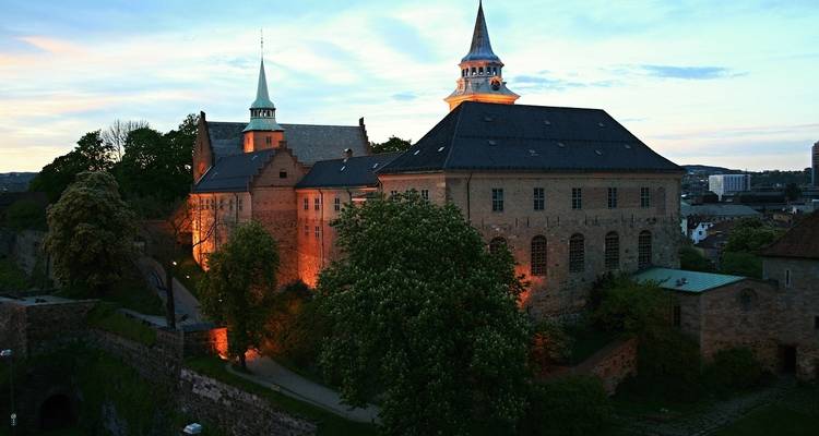 Château historique illuminé dans la soirée.