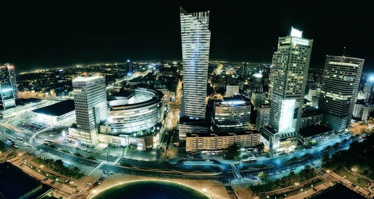 Vista nocturna de un horizonte urbano vibrante con rascacielos iluminados.