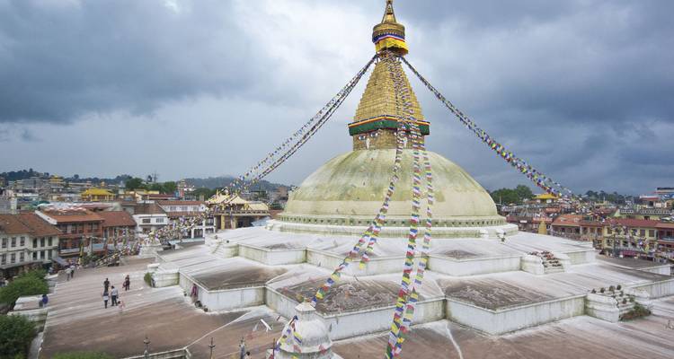 Boudhanath Stupa envuelto en banderas de oración contra dramáticas nubes de tormenta sobre Katmandú
