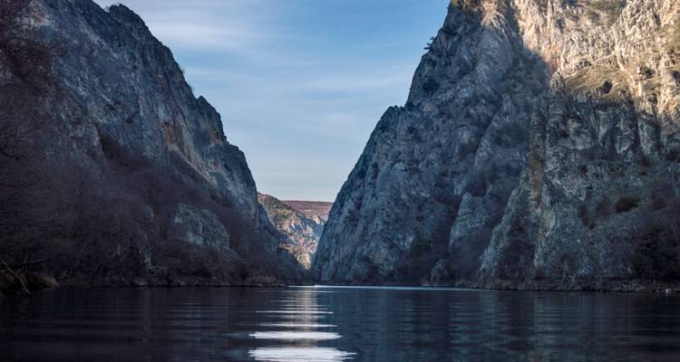Bergachtige kloof met water dat er doorheen stroomt.