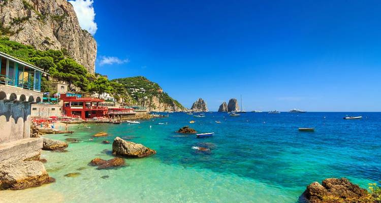 Coastal view with rocky shore and clear blue sea.