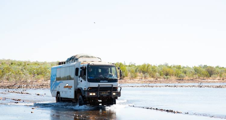 Camion 4x4 de voyage traversant une riviere peu profonde en 4x4 dans l'Outback