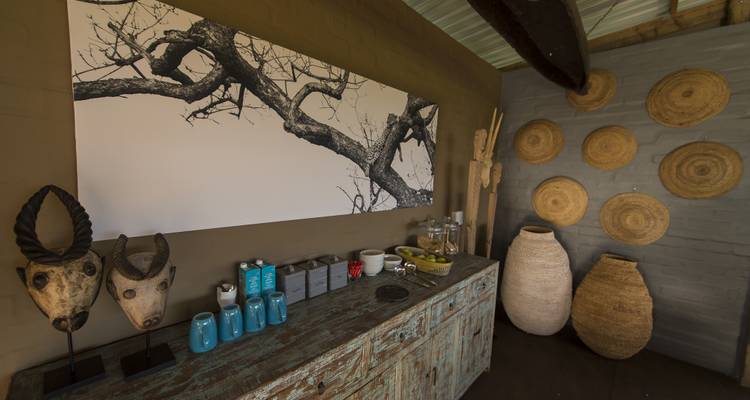 Artistic interior decor with masks and pottery.