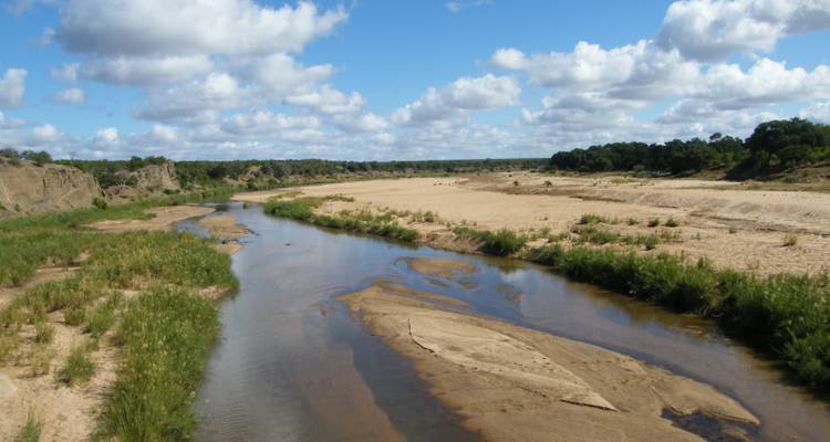 Scenic view of a river flowing through sandy banks.