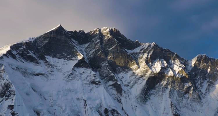 Une vue rapprochée d'un sommet de montagne éclairé par la lumière du soleil.