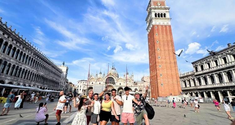 Group of people posing in St. Mark's Square with a bell tower