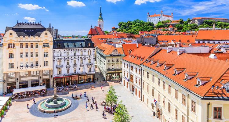 Vista aérea de una plaza de la ciudad con una fuente y edificios históricos, posiblemente en Bratislava.