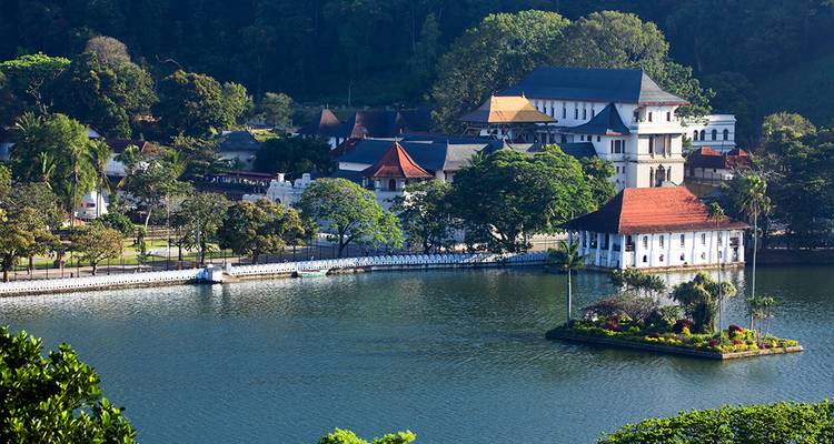 Scenic lakefront view of the Temple of the Tooth complex in Kandy.