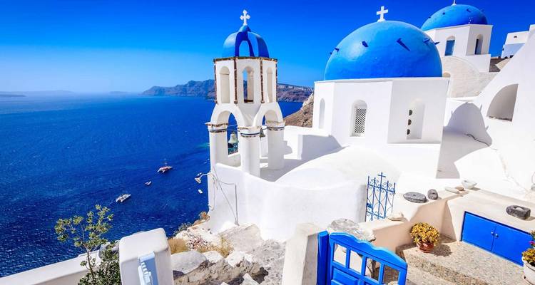 Santorini's iconische gebouwen met blauwe koepels met uitzicht op zee.