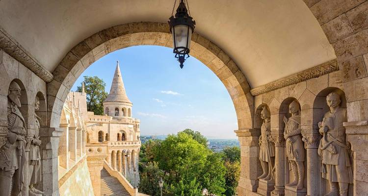 Une arche de pierre encadre les tourelles du Bastion des pêcheurs et les vues lointaines de la ville à Budapest.