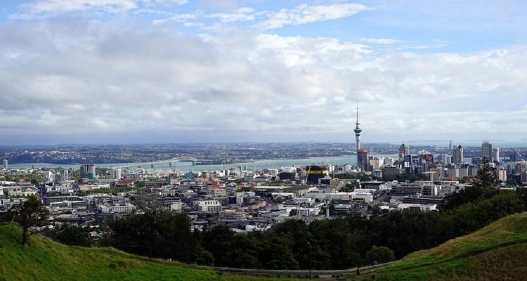 Cityscape of Auckland, New Zealand with a view of the harbor and the Sky Tower.