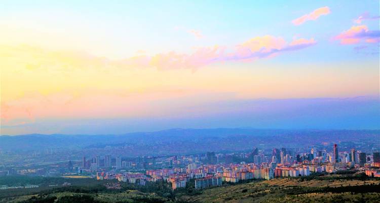 A cityscape view during sunset with pastel skies.